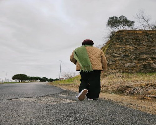 person walking wearing warm comfortable clothes on a cloudy day